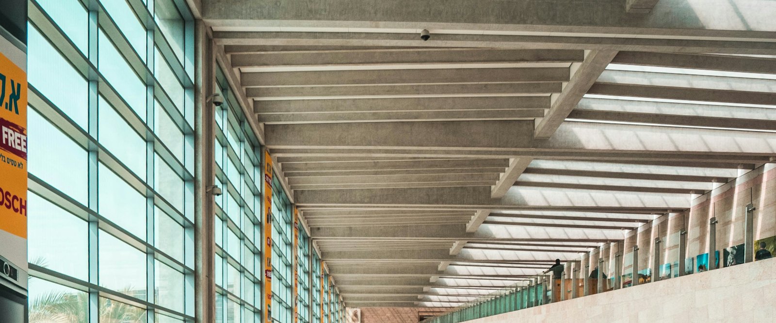 Passengers walking through a bright airport concourse