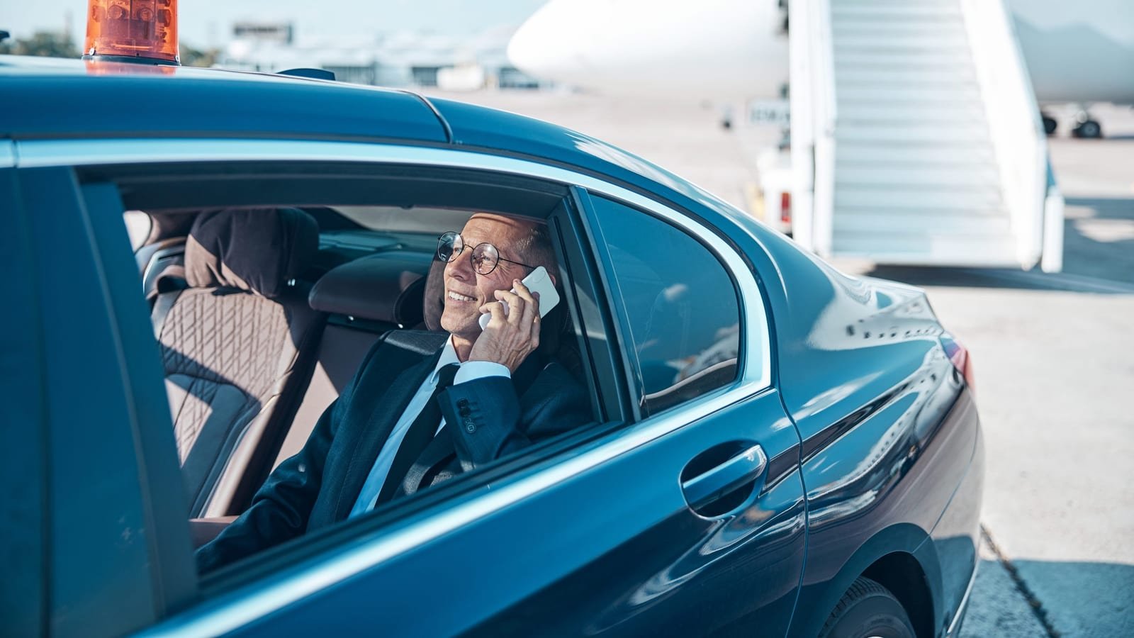 A traveller settling into the back seat after landing