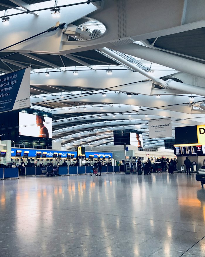 Passengers moving through an airport departures hall