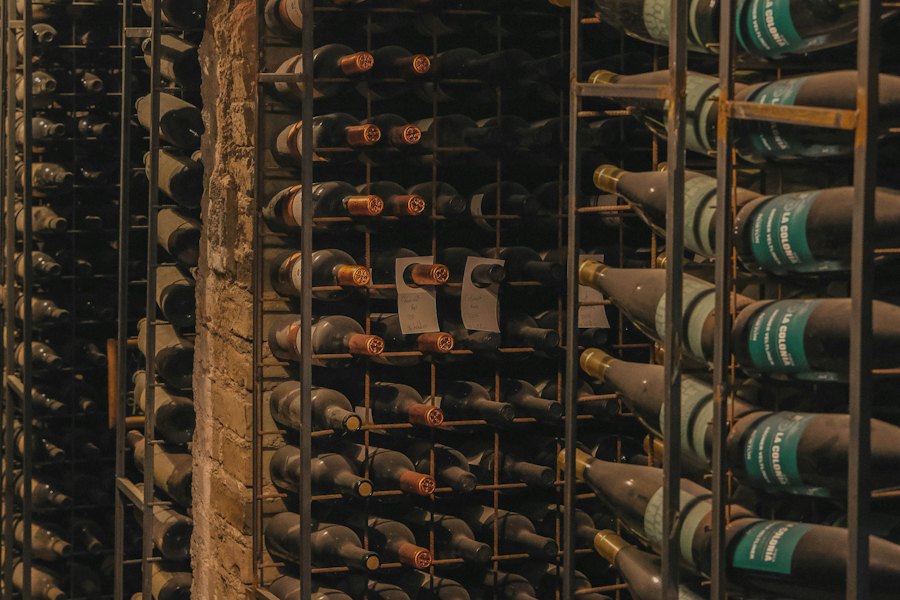 Bottles resting in a winery cellar