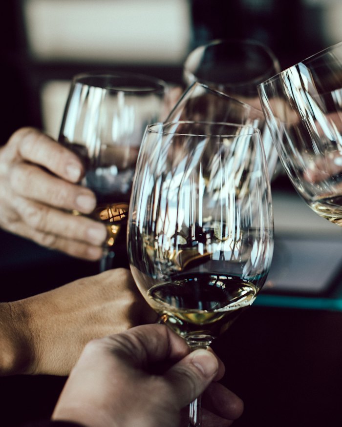 A group holding glasses at a tasting