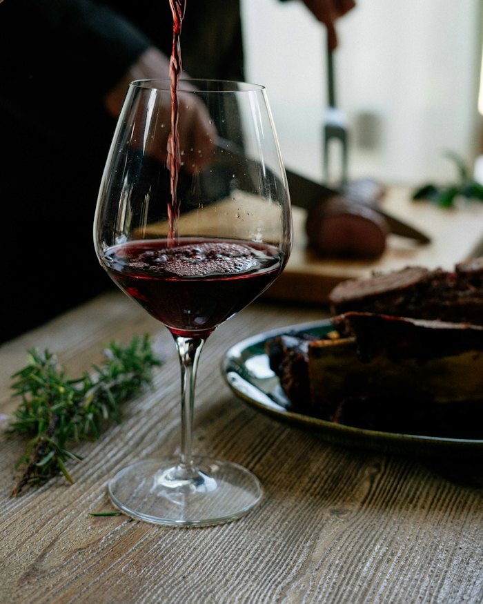 Red wine being poured into a glass