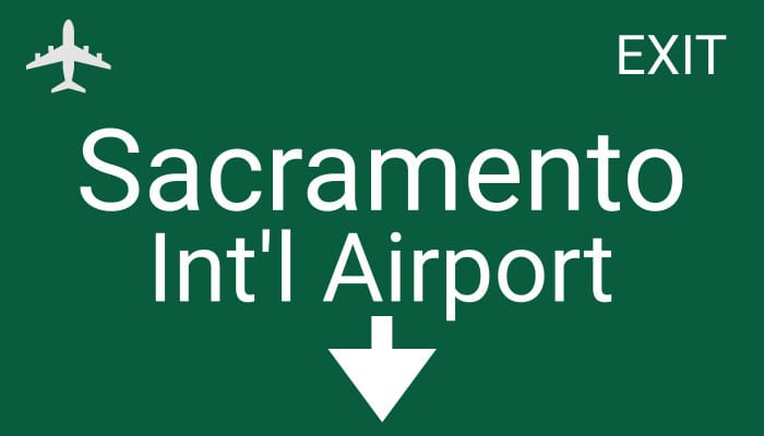 Sacramento International Airport exit sign for shuttle services by Travis Airport Shuttle
