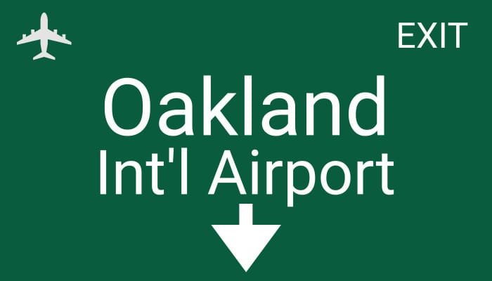 Oakland International Airport exit sign for Travis Airport Shuttle services